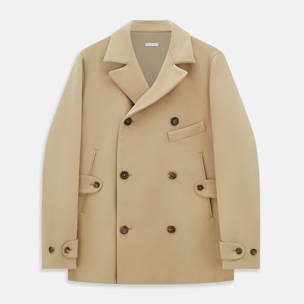 The Camel Wellington Double-Breasted Caban Coat by Turnbull & Asser features wide lapels, dark buttons, front flap and chest pockets, plus buttoned cuffs—perfect for elevating your formal wear collection.