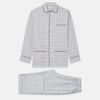 View 1 of product The Turnbull & Asser Blue Multi Check Cotton-Cashmere Modern Pyjama Set features a two-piece design with a long-sleeve button-up top with breast pocket and matching elastic-waist pants in a blue and white check pattern.