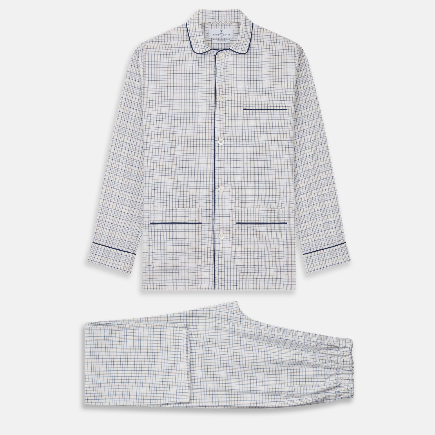 View 1 of product The Turnbull & Asser Blue Multi Check Cotton-Cashmere Modern Pyjama Set features a two-piece design with a long-sleeve button-up top with breast pocket and matching elastic-waist pants in a blue and white check pattern.