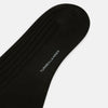 View 3 of product A single Dark Chocolate Long Sock by Turnbull & Asser is displayed against a plain white background, showcasing its knee-high length and foot shape.