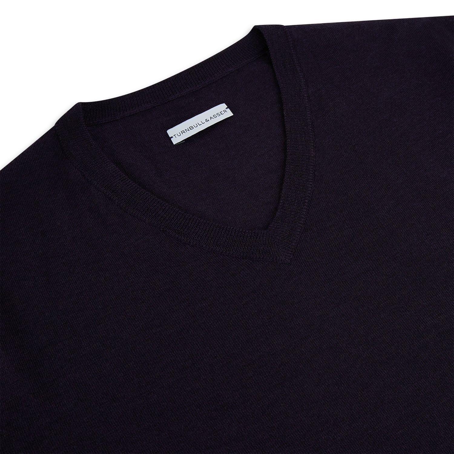 View 2 of product The Turnbull & Asser Dark Purple Fine Merino V-Neck Jumper features long sleeves and a classic knit, shown against a white background.