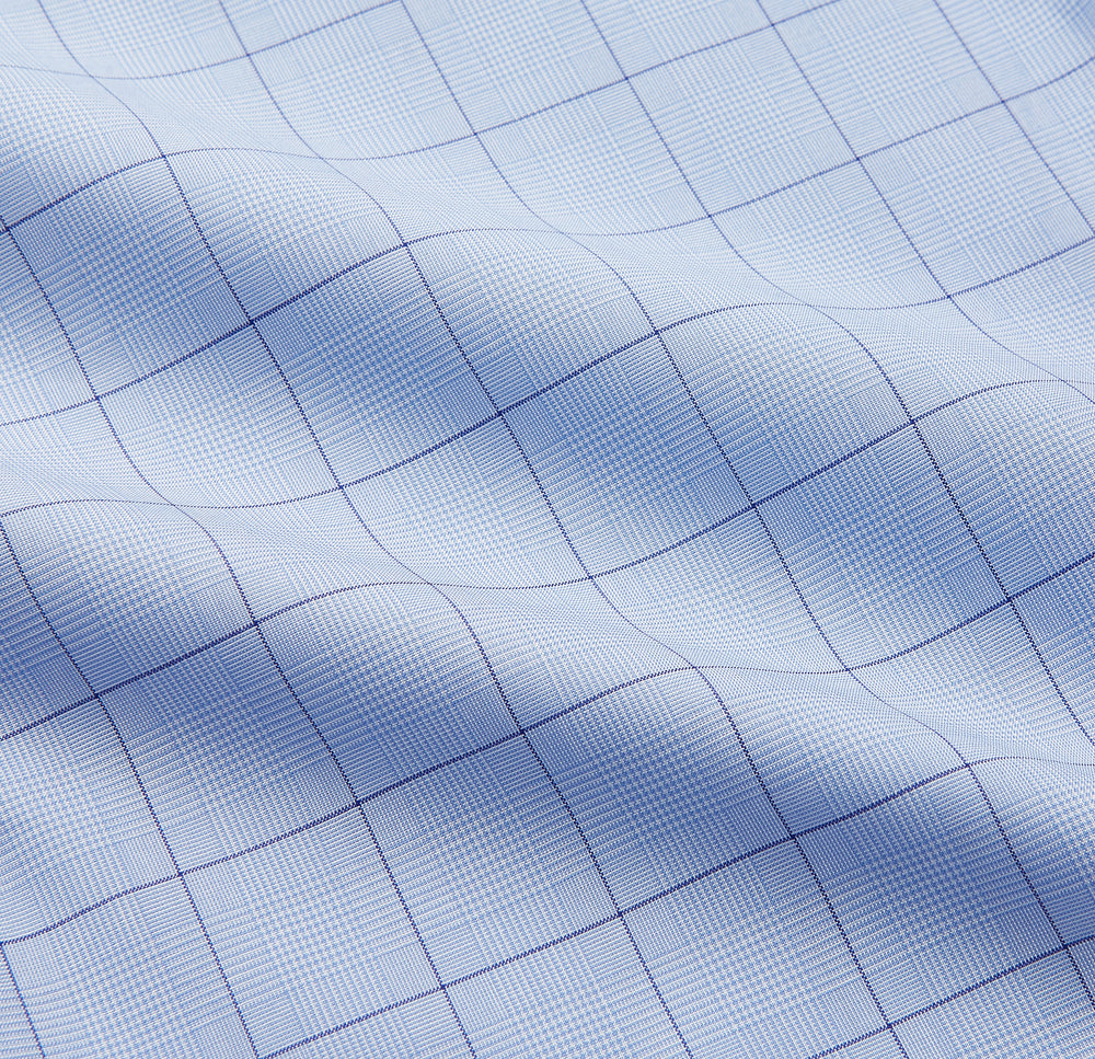 The Blue Prince of Wales Check Mayfair Shirt by Turnbull & Asser features a light blue check pattern, white buttons, and a classic collar. Crafted from premium Italian cotton, it is displayed on a plain white background.