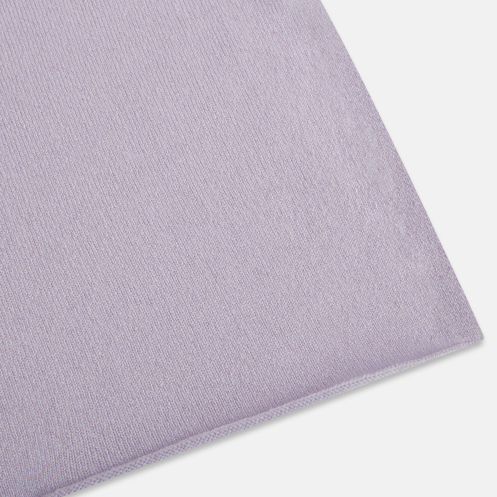 The Turnbull & Asser Plain Lilac Cashmere Knitted Scarf is shown neatly tied in a loose knot against a plain white background, highlighting its elegant and timeless design.