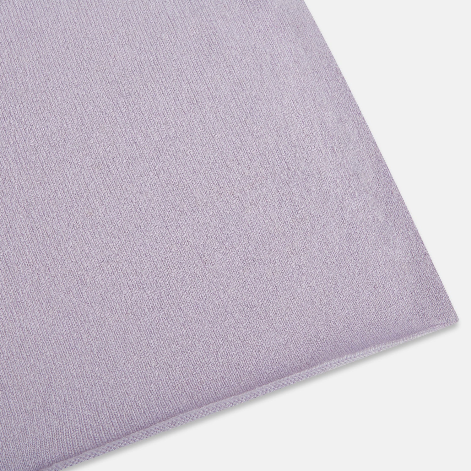 View 2 of product The Turnbull & Asser Plain Lilac Cashmere Knitted Scarf is shown neatly tied in a loose knot against a plain white background, highlighting its elegant and timeless design.