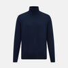 View 1 of product The Turnbull & Asser Navy Fine Merino High Neck Jumper, a plain long-sleeved piece crafted from premium merino wool, is shown on a white background.