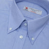 View 2 of product The Turnbull & Asser Blue Royal Oxford Cotton Shirt features a button-down collar, 3-button cuffs, and a visible brand label, shown neatly folded on a white background—ideal for pairing with a navy suit.