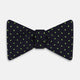 The Turnbull & Asser Lime Green and Navy Micro Dot Silk Bow Tie features small lime green dots on navy silk, displayed against a plain white background.