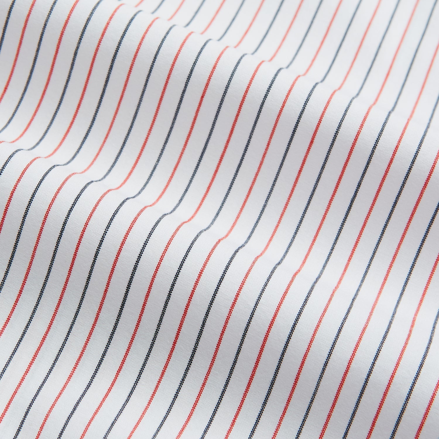 View 4 of product The Turnbull & Asser Hand Rolled Red and Navy Pinstripe Handkerchief features evenly spaced vertical stripes on white cotton, offering a clean, classic look as an elegant gentleman's accessory or stylish pocket square.