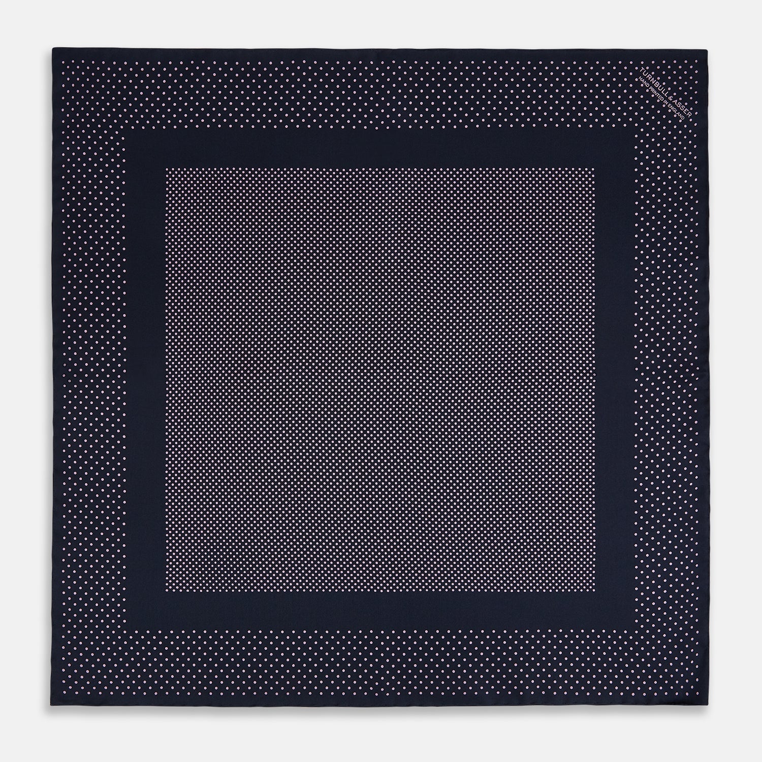 View 3 of product The Turnbull & Asser Navy and Lilac Dot Silk Pocket Square features small white polka dots with a wider border of spaced-out dots, neatly folded to showcase both sides of its handmade silk fabric.