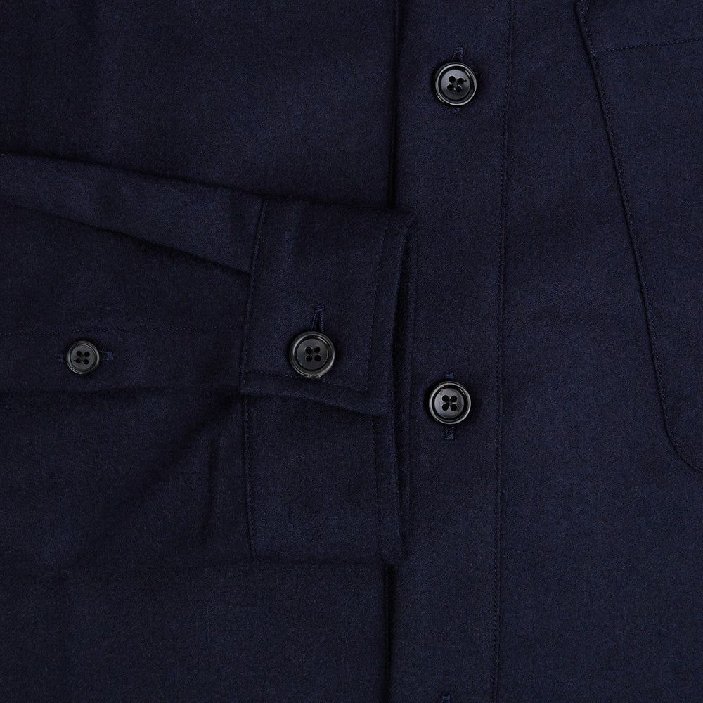 The Turnbull & Asser Midnight Blue Highbury Overshirt, featuring long sleeves, a collar, and a single chest pocket, is shown laid flat against a white background.
