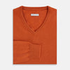 View 4 of product The Turnbull & Asser Rust Cashmere V-neck Jumper features long sleeves, ribbed cuffs and hem, and is shown against a plain white background.