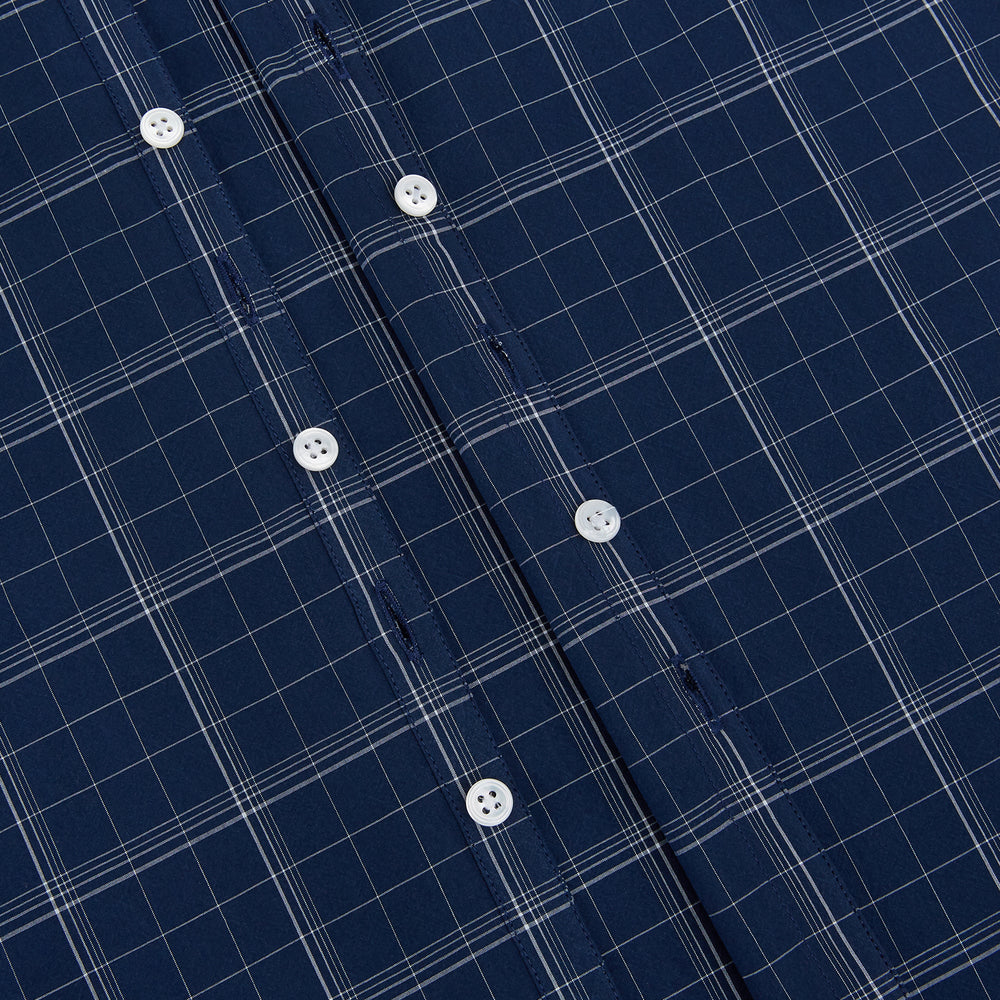 The Indigo and White Thin Plaid Check Windsor Shirt by Turnbull & Asser, a long-sleeve button-up with white buttons, is shown laid flat on a white background.