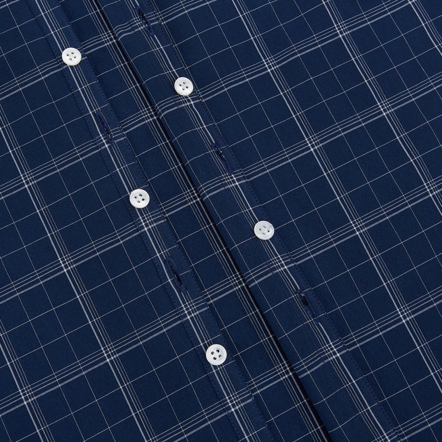 View 7 of product The Indigo and White Thin Plaid Check Windsor Shirt by Turnbull & Asser, a long-sleeve button-up with white buttons, is shown laid flat on a white background.