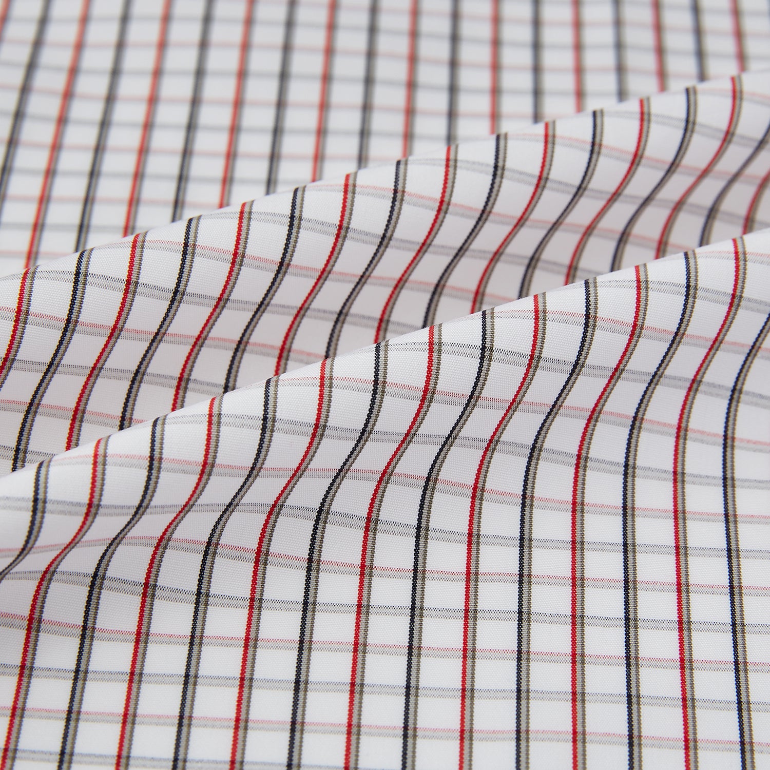 View 8 of product The Turnbull & Asser Red and Midnight Blue Tattersall Check Windsor Shirt features British craftsmanship, shown laid flat with sleeves extended and collar neatly folded.