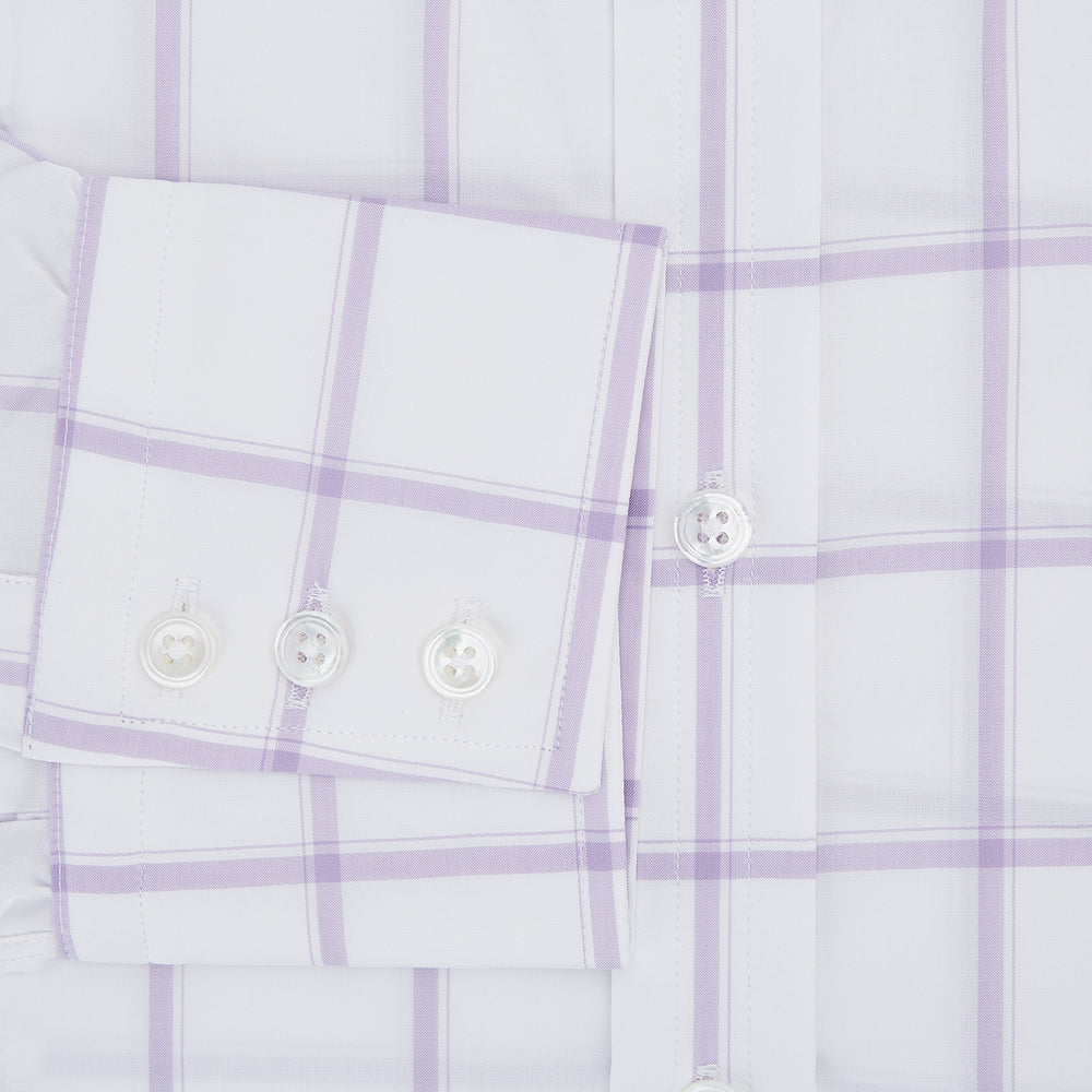 The Turnbull & Asser Lilac Grid Check Mayfair Shirt is a long-sleeve, button-up style crafted from Italian cotton with a white base and lilac grid check pattern, shown on a plain white background.