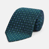 View 1 of product The MINI SQUARE SPOT FOREST GREEN BLUE TIE by Turnbull & Asser is a classic men's accessory, featuring a rolled-up green silk design with small blue geometric patterns—perfect for the modern gentleman.
