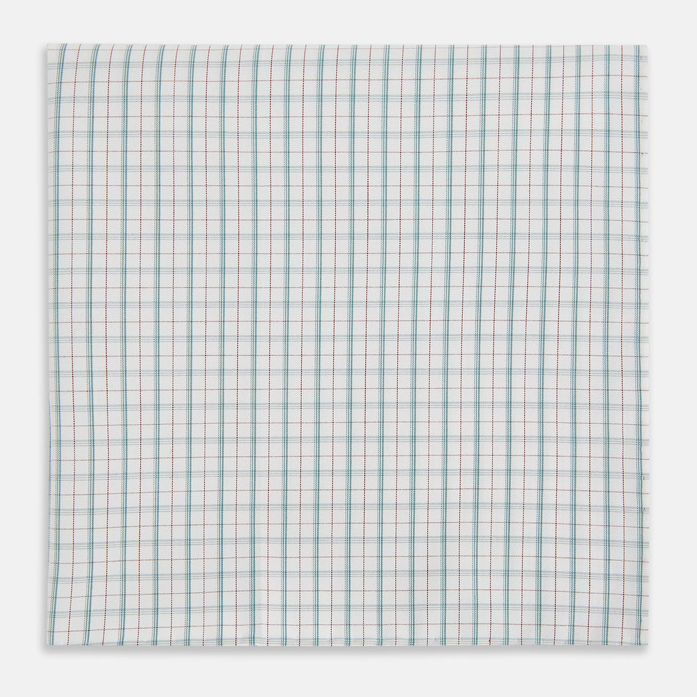The Turnbull & Asser Green Multi Graph Check Hand-Rolled Handkerchief features a graph check pattern with thin colorful lines forming small squares, hand-rolled edges, and is laid flat against a white background.