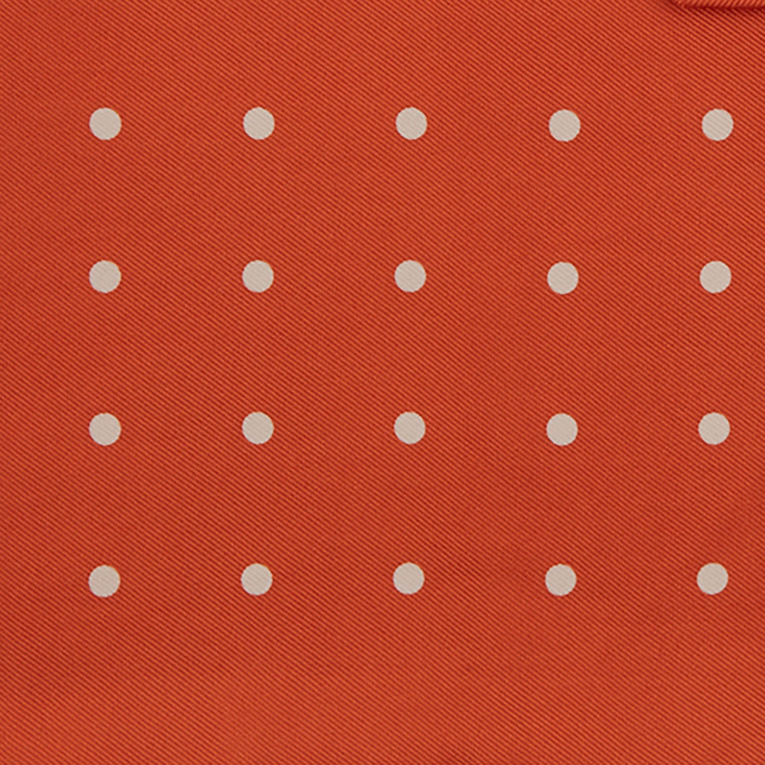 View 3 of product The Orange Spot Silk Pocket Square by Turnbull & Asser features evenly spaced white polka dots and the brand’s name in one corner, making this dapper accessory a standout addition to any outfit.