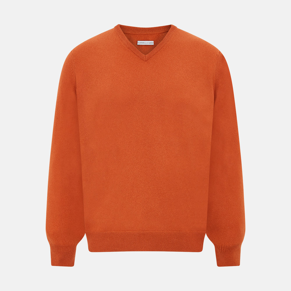 The Turnbull & Asser Rust Cashmere V-neck Jumper features long sleeves, ribbed cuffs and hem, and is shown against a plain white background.