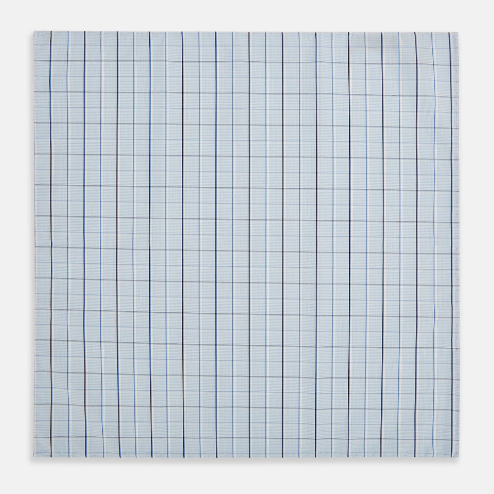 The Turnbull & Asser Navy and Blue Combination Check Hand-Rolled Handkerchief features a classic check pattern in navy and blue with thin white lines, shown laid flat on a white background.