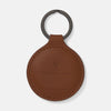 View 1 of product A tan circular leather fob holder by Turnbull & Asser, featuring visible stitching, embossed branding, and 'Made in England,' attached to a metal key ring.