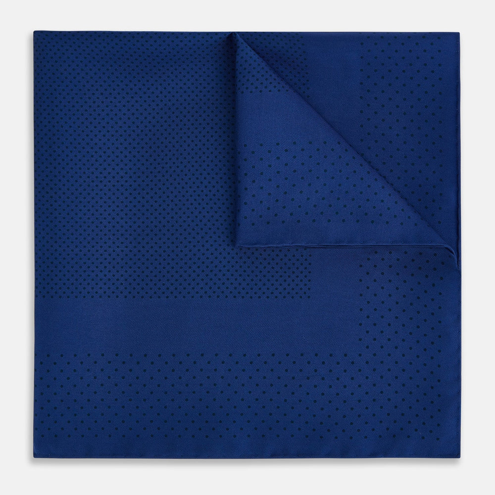 The Turnbull & Asser Navy Dot Silk Pocket Square, folded with neat hand-rolled edges, features a subtle navy polka dot pattern on dark blue silk and is shown against a white background.