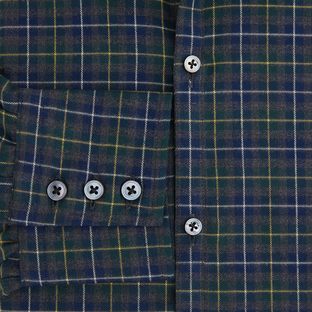 The Turnbull & Asser Navy and Khaki Tartan Windsor Shirt features a long-sleeve button-up design with a Windsor collar and buttoned cuffs, showcasing British craftsmanship in a classic tartan pattern.