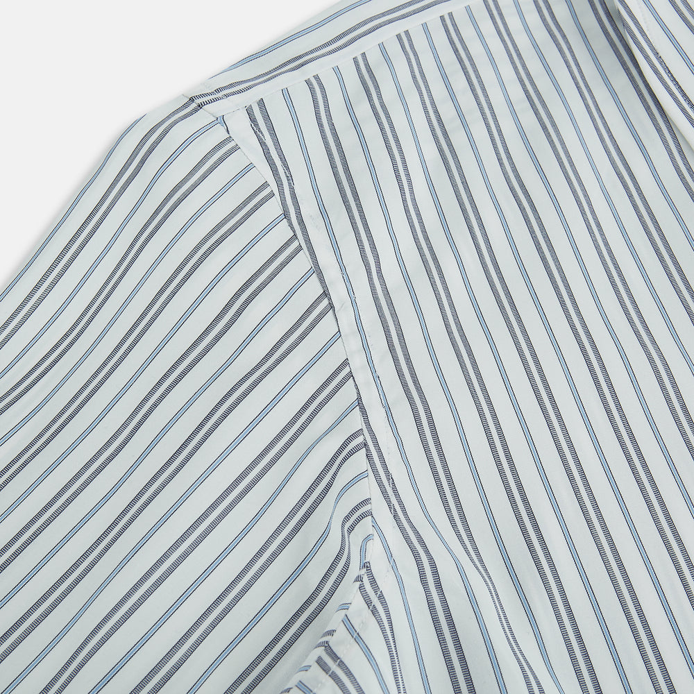 The Turnbull & Asser Navy and Light Blue Multi Track Stripe Westminster Shirt, featuring a button-up design with long sleeves and a signature collar, is displayed flat to highlight its expert British craftsmanship.