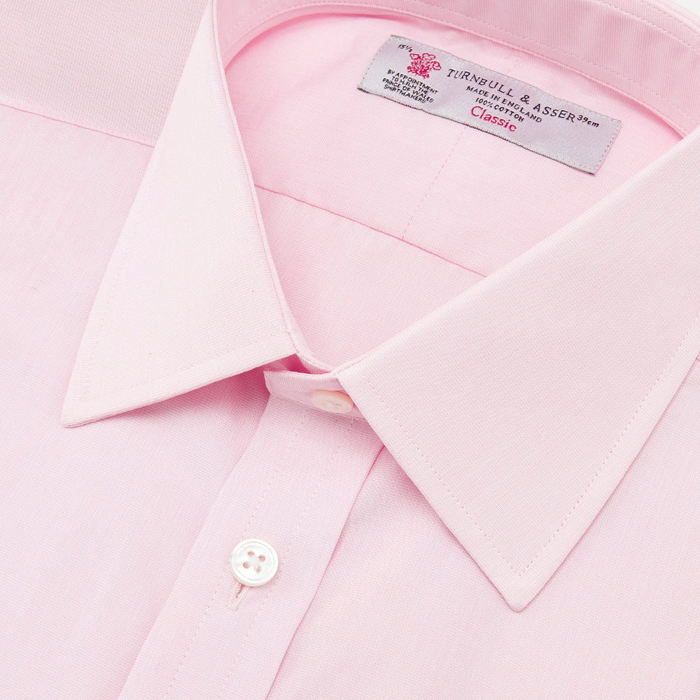 The Pink End-on-End Shirt with T&A Collar and Double Cuffs by Turnbull & Asser, shown neatly folded on a white background, updates timeless elegance with its classic detailing and refined pink hue.