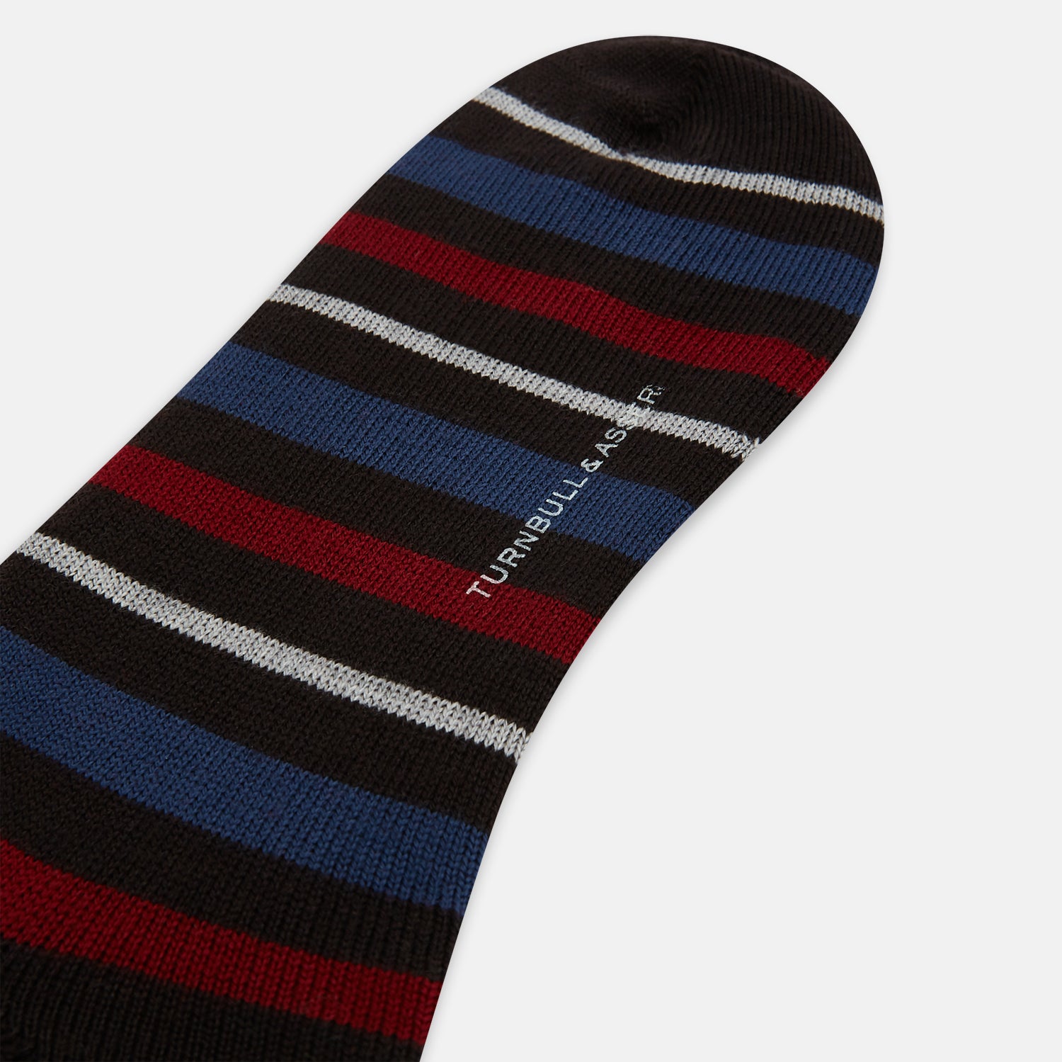 View 3 of product The Turnbull & Asser Dark Chocolate Striped Merino Wool Long Socks are knee-high, featuring horizontal black, red, blue, and gray stripes on a white background.