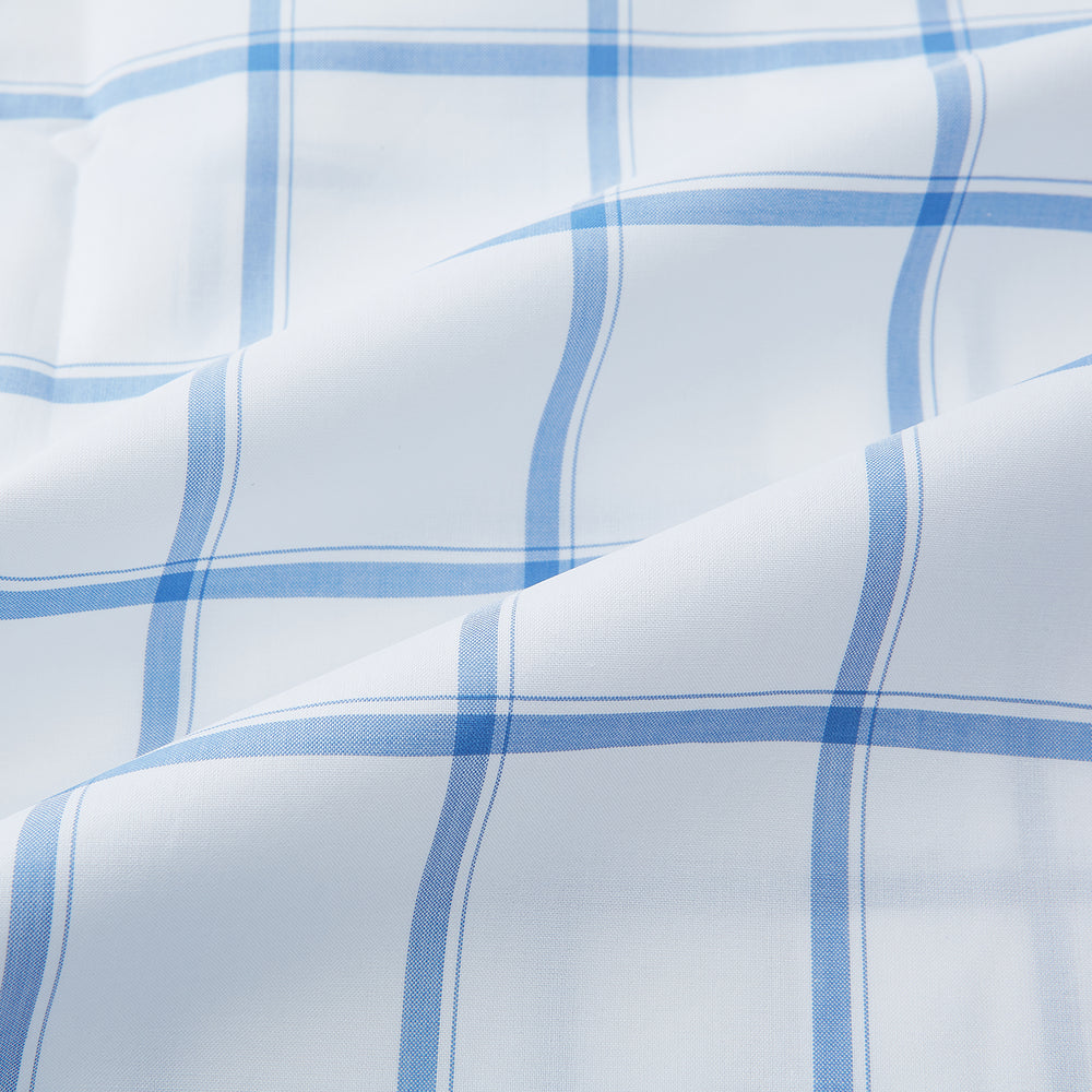 The Turnbull & Asser Colony Blue Grid Check Mayfair Shirt features long sleeves, a button-down front, Italian cotton fabric, a spread collar, and buttoned cuffs, shown against a plain white background.