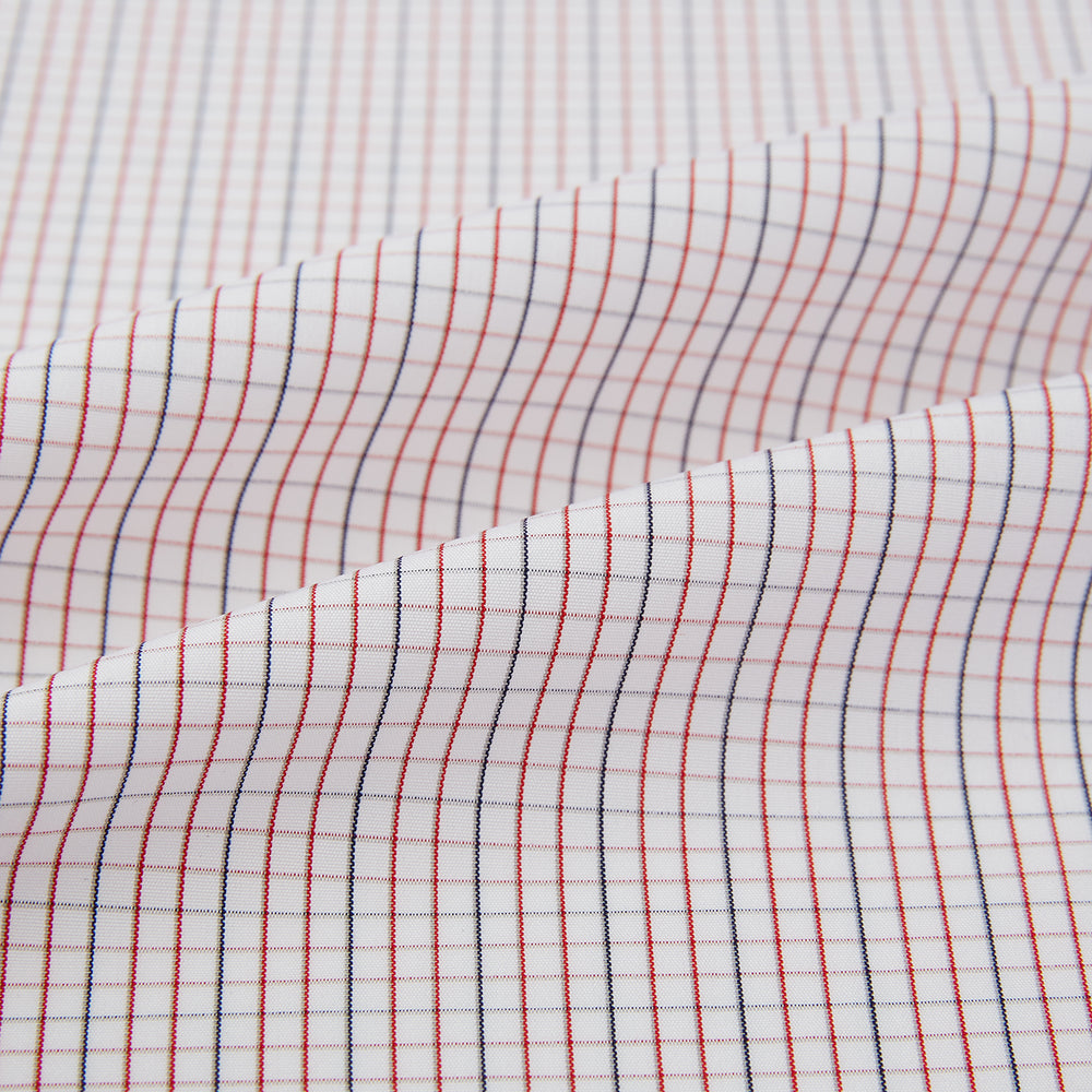 The Turnbull & Asser Red and Navy Check Windsor Shirt features a pointed collar and cuffed long sleeves, highlighting British craftsmanship. Displayed flat on a white background.