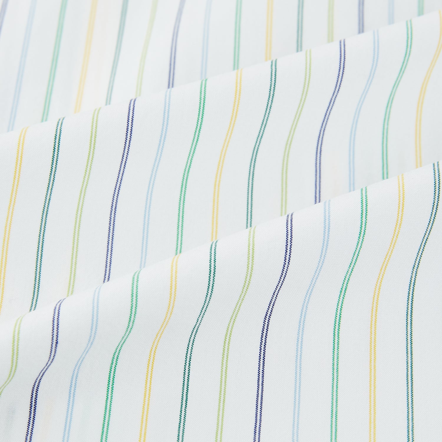 View 6 of product The Turnbull & Asser Multi Tone Double Pinstripe Mayfair Shirt is a long-sleeve pure cotton shirt with a collar and thin blue, green, and yellow double pinstripes on a white background.