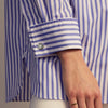 View 8 of product The Turnbull & Asser Pale Blue Candy Stripe Cotton Marlene Shirt is an oversized women's collared shirt with long sleeves, buttoned cuffs, and vertical blue and white stripes, shown laid flat on a white background.