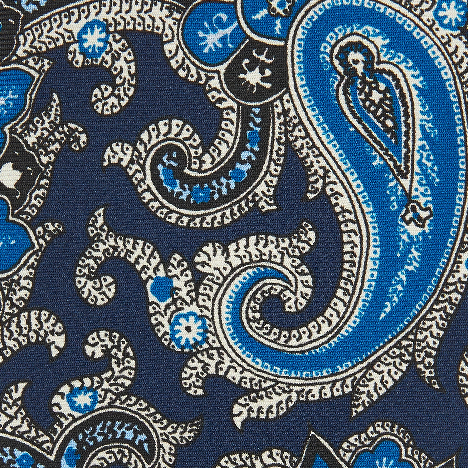 View 3 of product The Turnbull & Asser Blue and Navy Twisted Paisley Silk Tie displays intricate blue, white, and black details, rolled up against a plain white background.