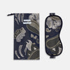 View 2 of product The Turnbull & Asser Navy Bloomsbury Jacquard Cashmere Lined Sleep Mask and Bag features a dark blue backdrop with beige, olive green, and gray floral patterns, plus elastic straps for comfort.