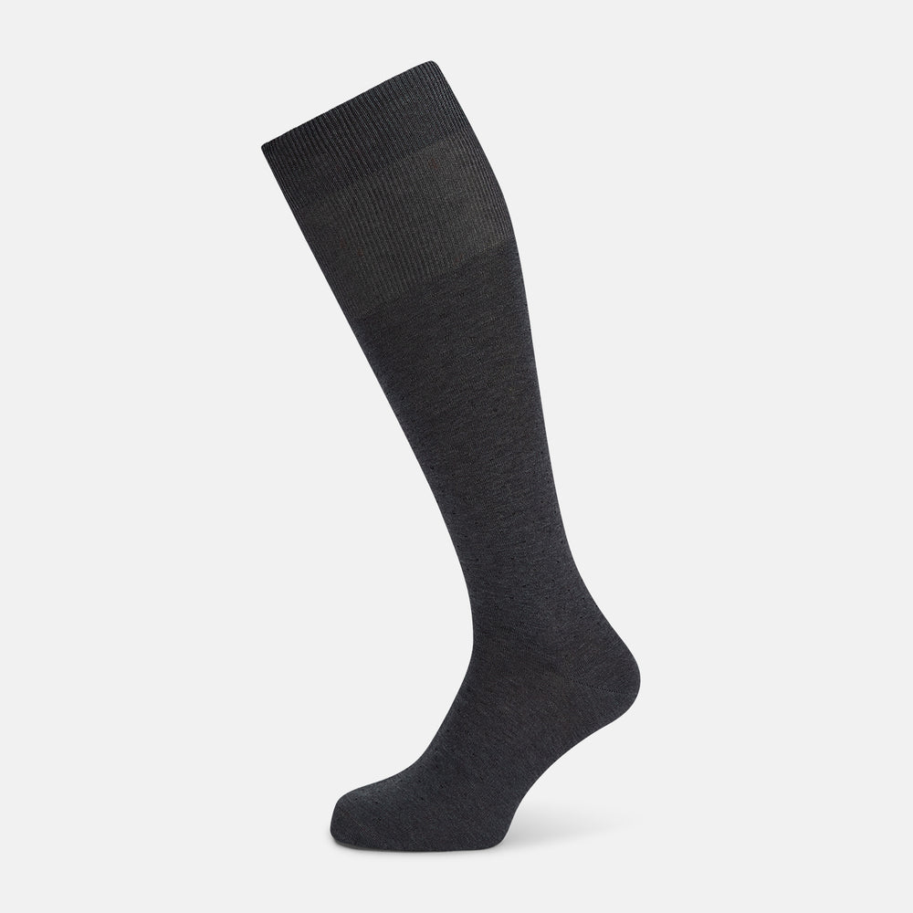 The Turnbull & Asser Steel/midnight Polka Dot Long Sock is shown in dark gray over the calf, displayed from the side on a white background with downward toe and ribbed top for a snug fit.