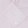 View 6 of product A Pink Herringbone Superfine Cotton Shirt by Turnbull & Asser, featuring a T&A collar and 3-button cuffs, is neatly folded with the inner collar label visible and white buttons, set against a plain white background.
