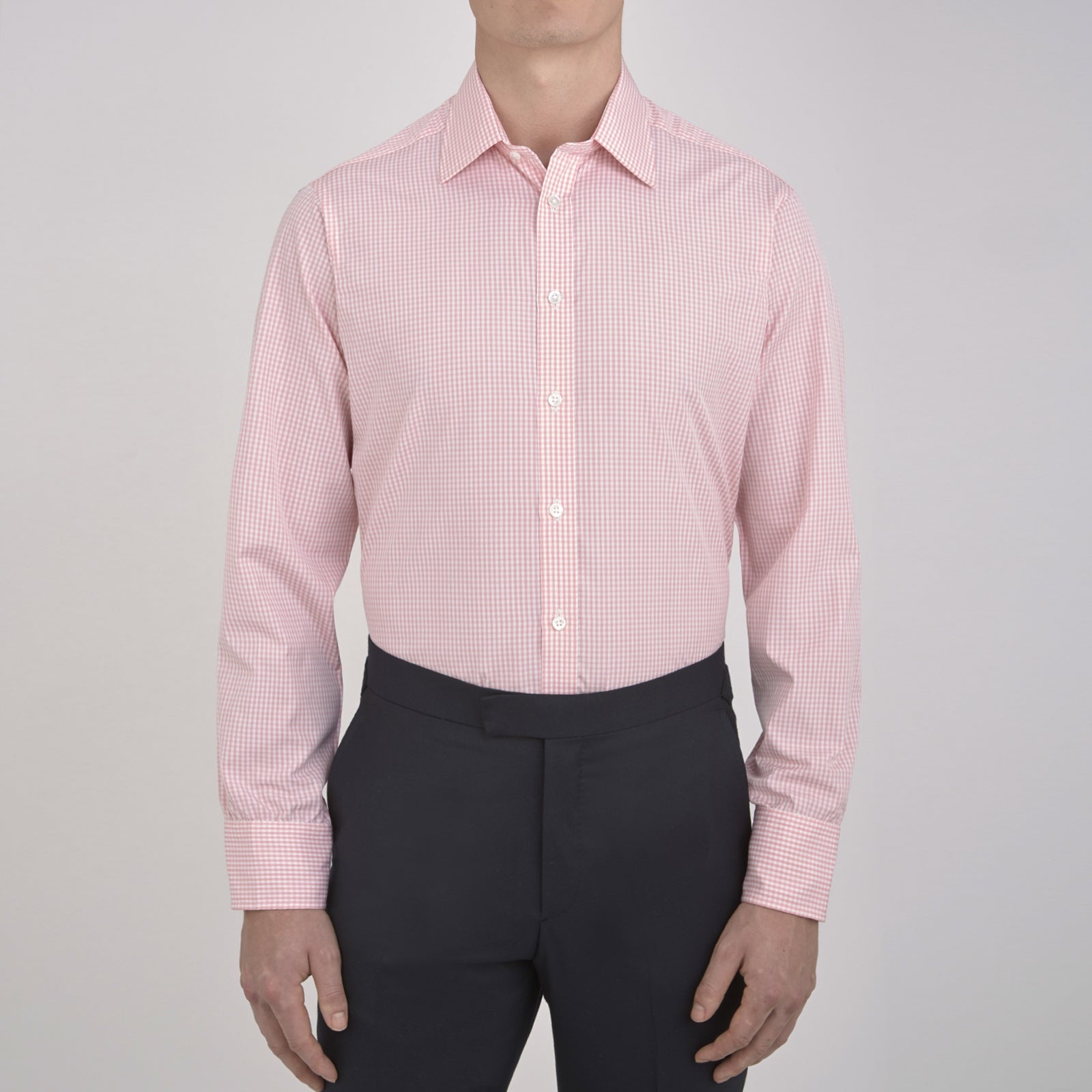 View 2 of product The Turnbull & Asser Light Pink Gingham Check Shirt features a classic T&A collar, 3-button cuffs, and white buttons, neatly folded on a plain white background.