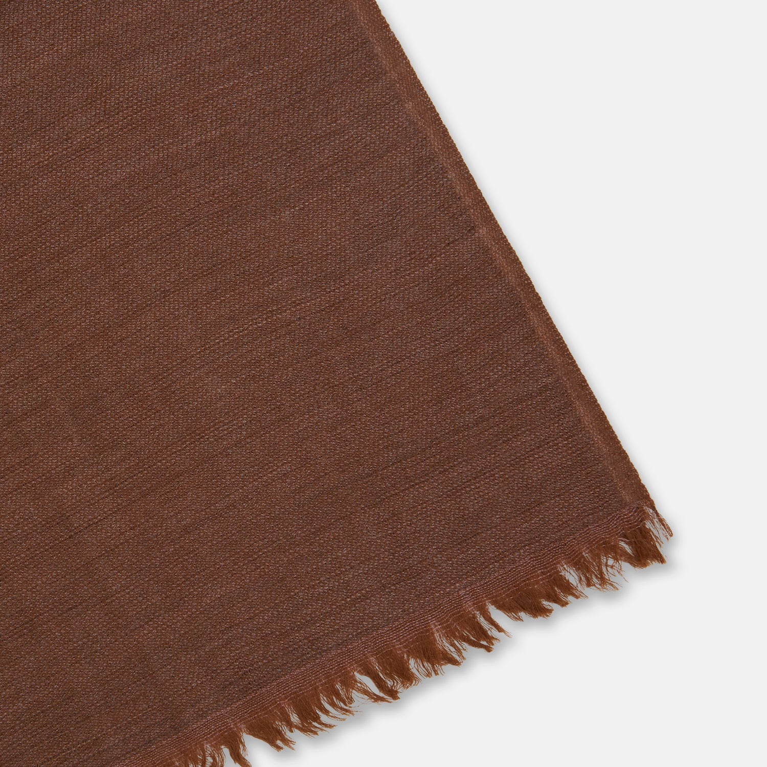 View 2 of product The Turnbull & Asser Brown Cashmere Scarf is ultra-soft with a smooth texture, short frayed edges, and is tied in a simple knot. Displayed against a plain white background.