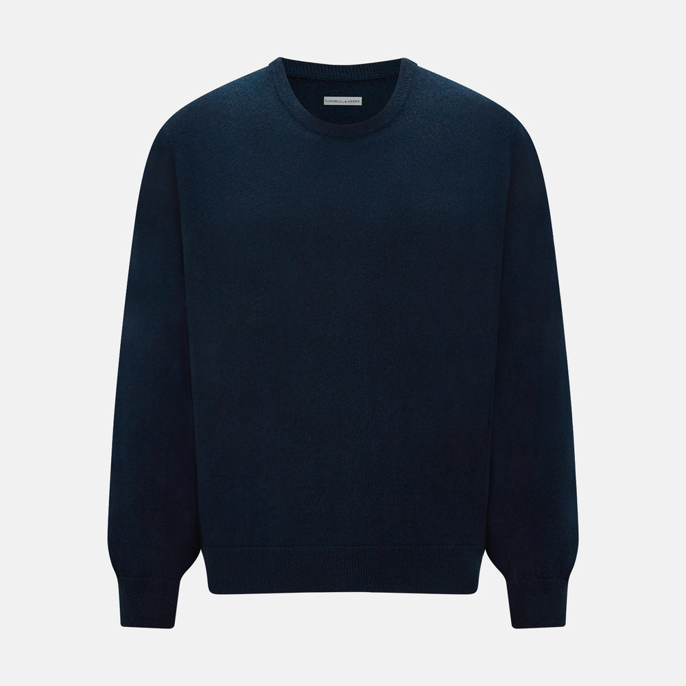 The Turnbull & Asser Navy Cashmere Round Neck Jumper for men is shown against a white background, featuring long sleeves, a relaxed fit, and ribbed cuffs, hem, and collar for an effortlessly elegant look.