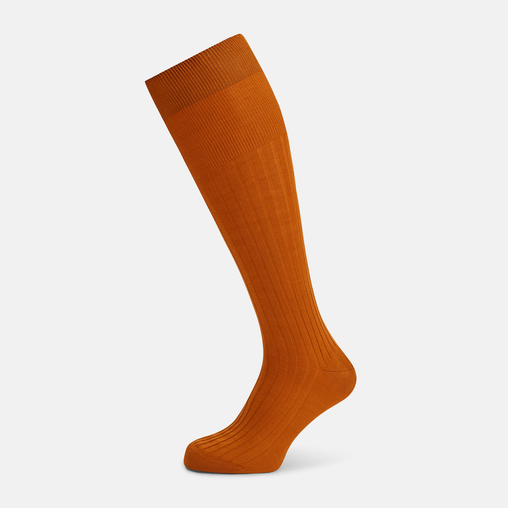 Turnbull & Asser Pumpkin Long Socks shown on a foot; bright orange and over the calf in length.