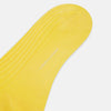 View 3 of product A single Charteuese Lemon Mid-Length Sock by Turnbull & Asser, knee-high and bright yellow with a ribbed Egyptian cotton texture, is displayed upright against a plain white background.