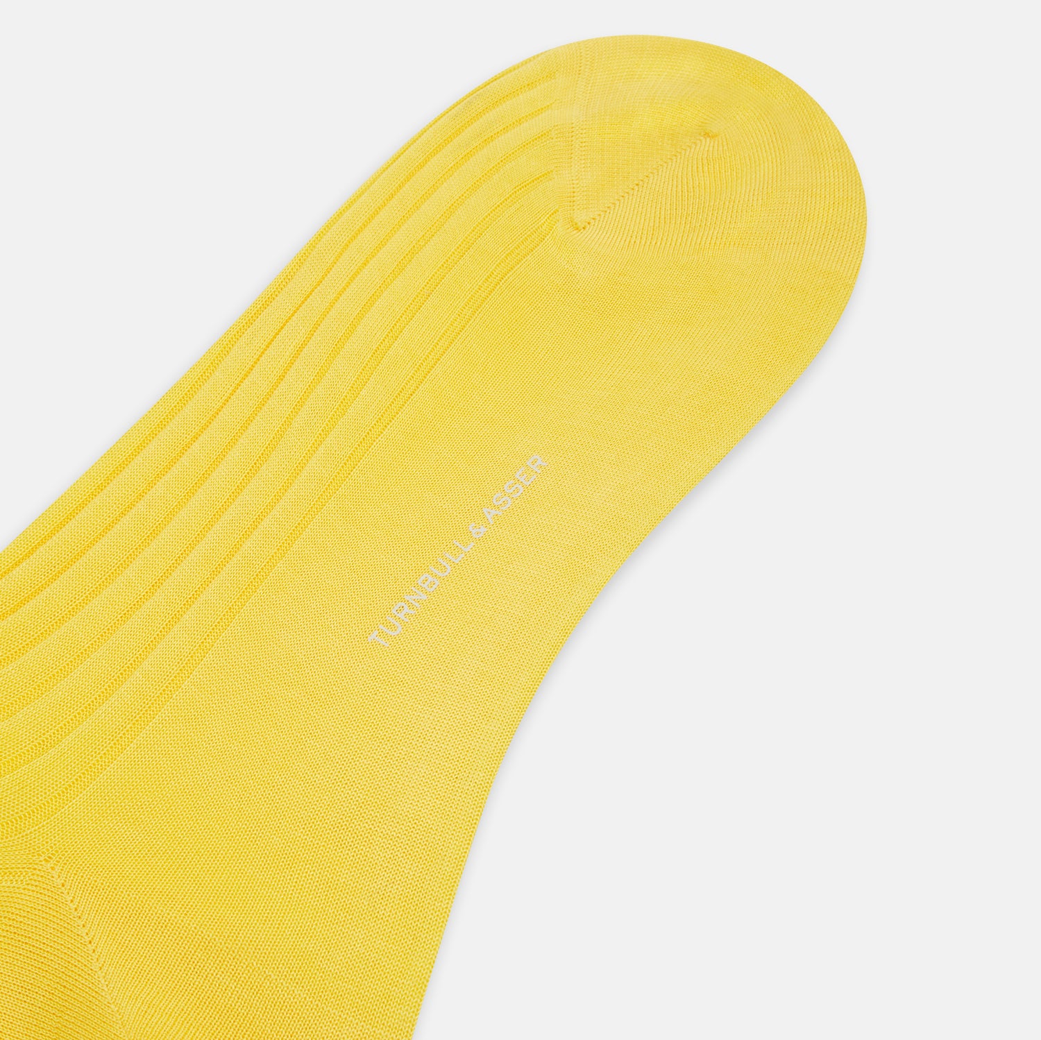 View 3 of product A single Charteuese Lemon Mid-Length Sock by Turnbull & Asser, knee-high and bright yellow with a ribbed Egyptian cotton texture, is displayed upright against a plain white background.