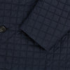 View 4 of product The Fulham Navy Single-Breasted Quilted Blazer by Turnbull & Asser features a notched lapel, three black buttons, a chest pocket, and two front flap pockets. Shown on a plain white background—ideal for the modern gentleman.