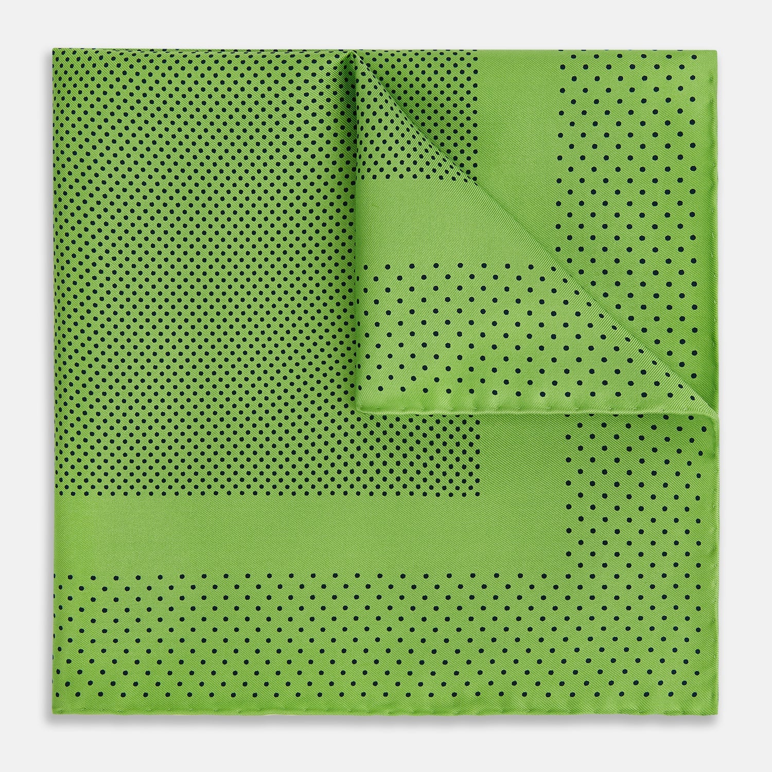 View 1 of product The Turnbull & Asser Kelly Green Dot Silk Pocket Square features small black polka dots and is shown neatly folded to showcase both its front and inner sides.