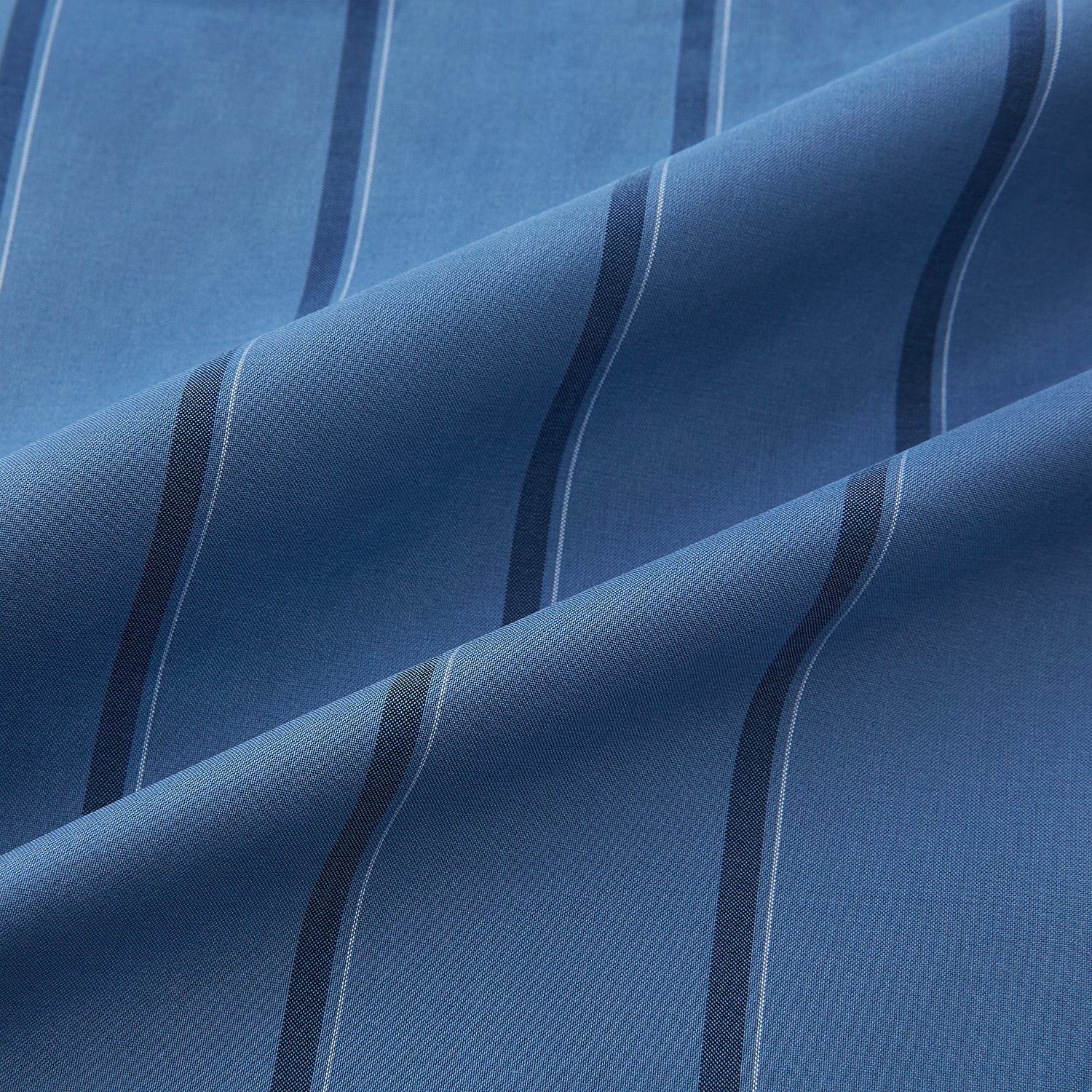 View 6 of product The Turnbull & Asser Steel Grey and Navy Track Stripe Mayfair Shirt features long sleeves, a collar, white buttons, and a relaxed fit, shown on a plain white background.