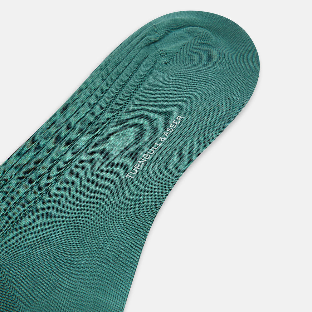 The Sage Long Sock by Turnbull & Asser is a knee-high, ribbed green sock made from premium Egyptian cotton, displayed against a plain white background.