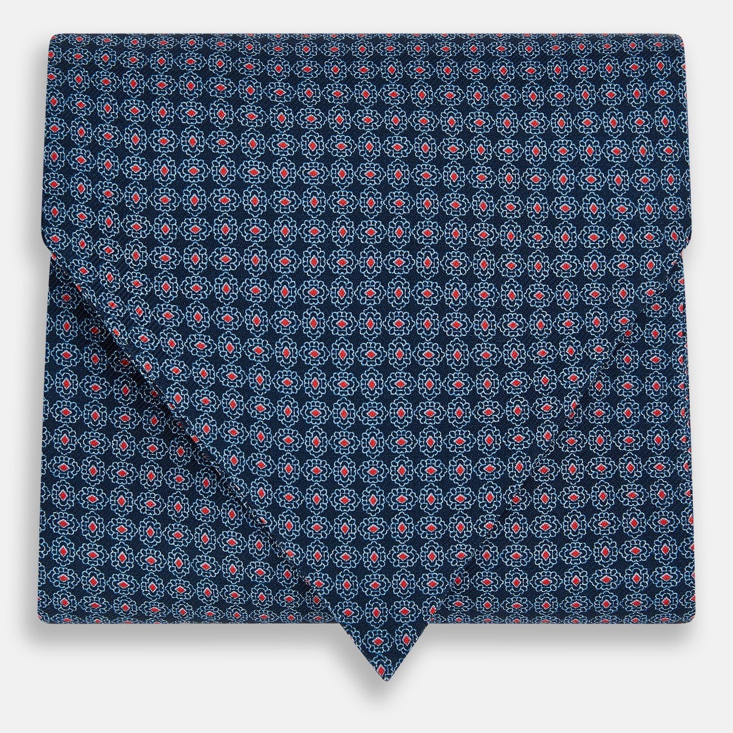 View 1 of product The Turnbull & Asser Navy and Red Rosette Cravat is adorned with a repeating geometric pattern of red, white, and light blue circles—an ideal formal accessory displayed against a white background.