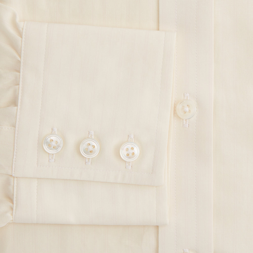 The Cream Fine Pencil Stripe Mayfair Shirt by Turnbull & Asser features long sleeves, a pointed collar, and buttoned cuffs. Crafted from breathable cotton with fine pencil stripes, it is shown laid flat on a white background.